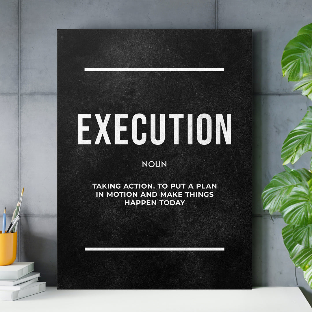 Motivační obraz Execution - Definice nad pracovním stolem.