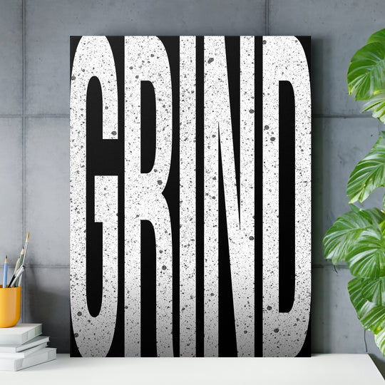 Motivační obraz Grind - Velká písmena nad pracovním stolem.