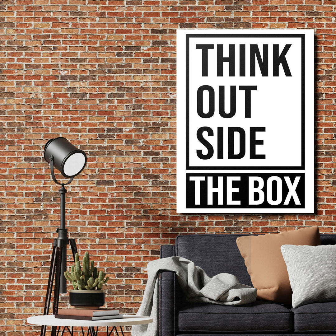 Motivační obraz na plátně THINK OUTSIDE THE BOX na cihlové zdi v industriálním obýváku