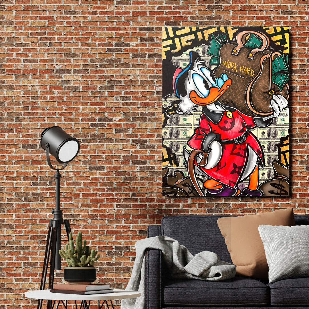 Motivační pop art obraz na plátně s Donaldem Drakem, LV taškou Work Hard a cihlovou zdí v obýváku