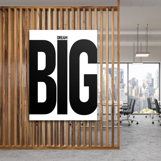 Motivační obraz na plátně s černým nápisem Dream BIG v moderní kanceláři za dřevěnou mříží