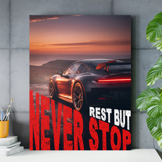 Motivační obraz na zeď s černým sportovním autem při západu slunce a červeným nápisem Never Stop