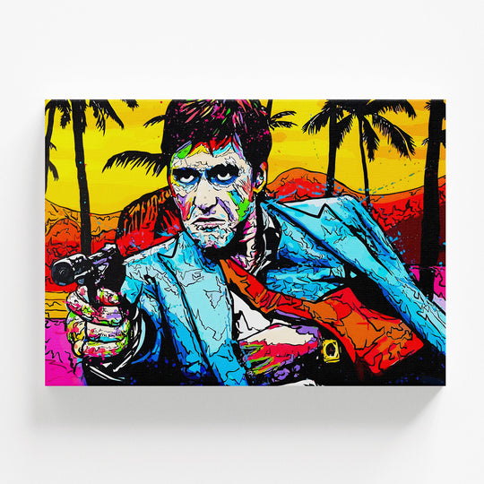 Pop art obraz Scarface s pistolí před palmami a oranžovým západem slunce v retro komiksovém stylu