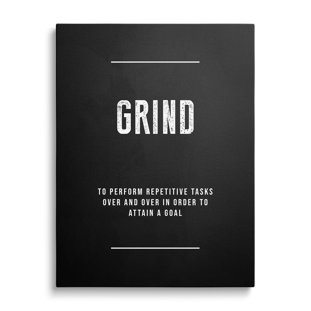 Motivační obraz na plátně s nápisem "GRIND" na bílé zdi